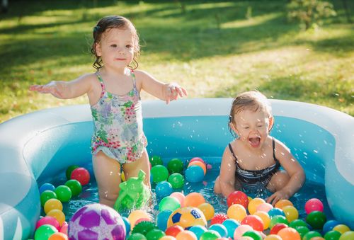 two-little-baby-girls-playing-with-toys-inflatable-pool-summer-sunny-day.jpg